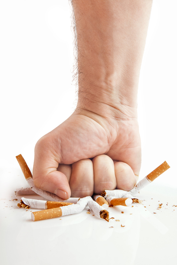 Human fist breaking cigarettes - anti-smoking concept